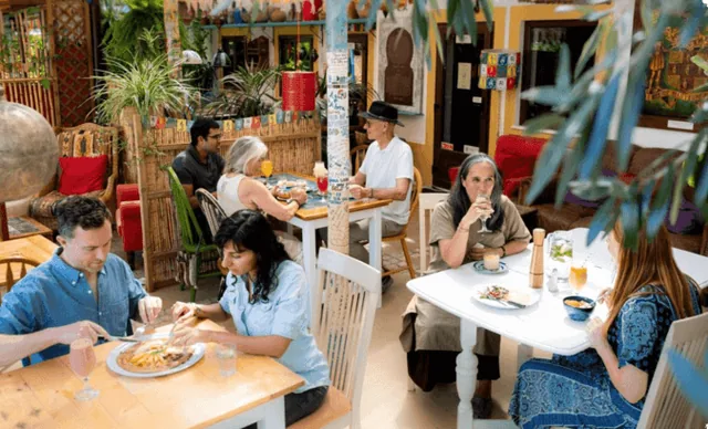 Guests eating in the colourful dining room at Casa Nirvana