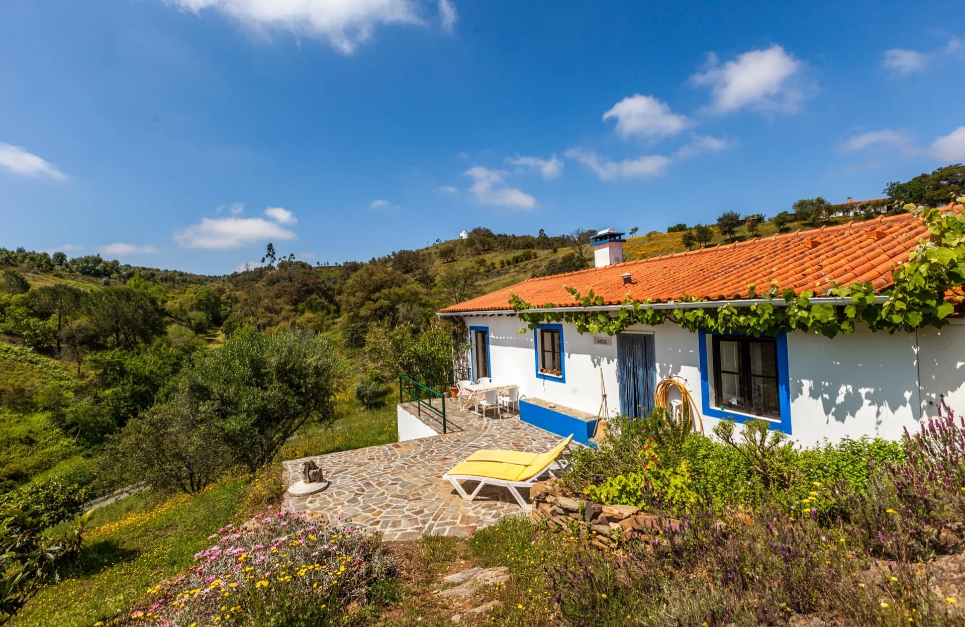 Casa Azul, a white house with blue trim and a terrace looking over the valley