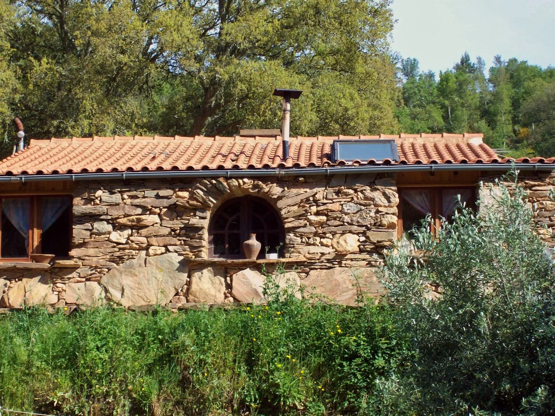 Restored schist cottage with terracotta roof