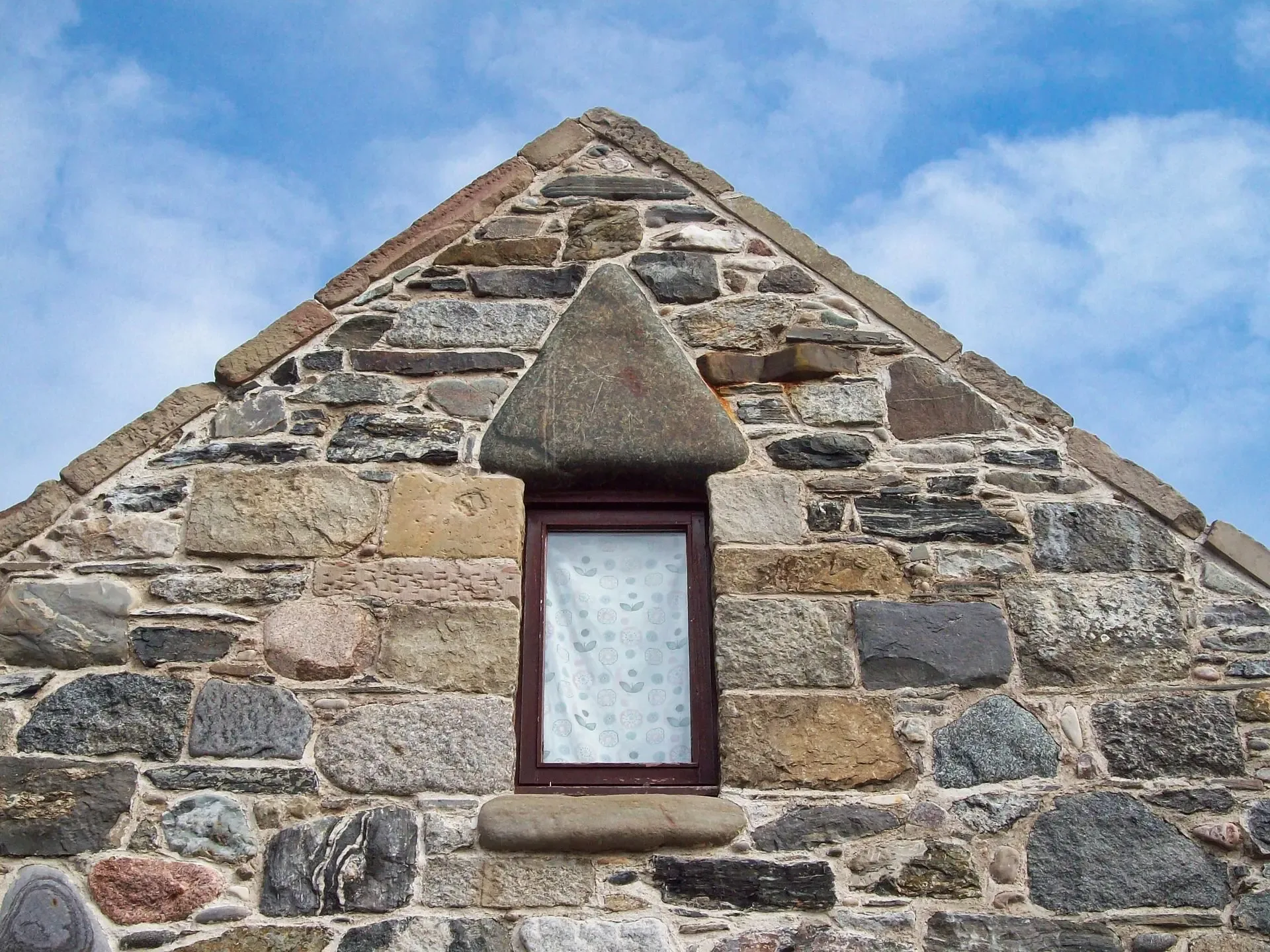 Stone gable with triangular window head