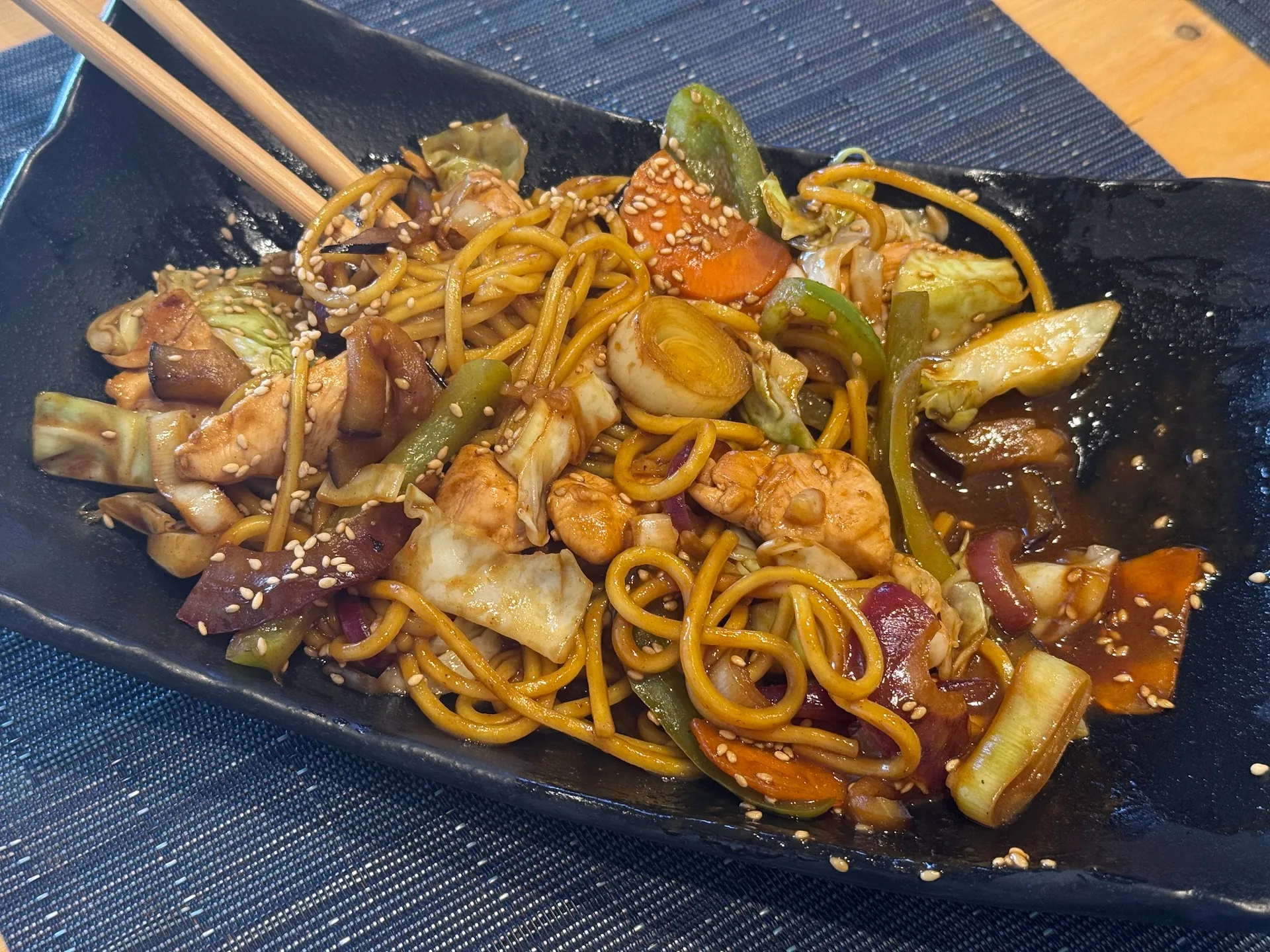 A plate of yakisoba noodles with vegetables at SAZANAMI